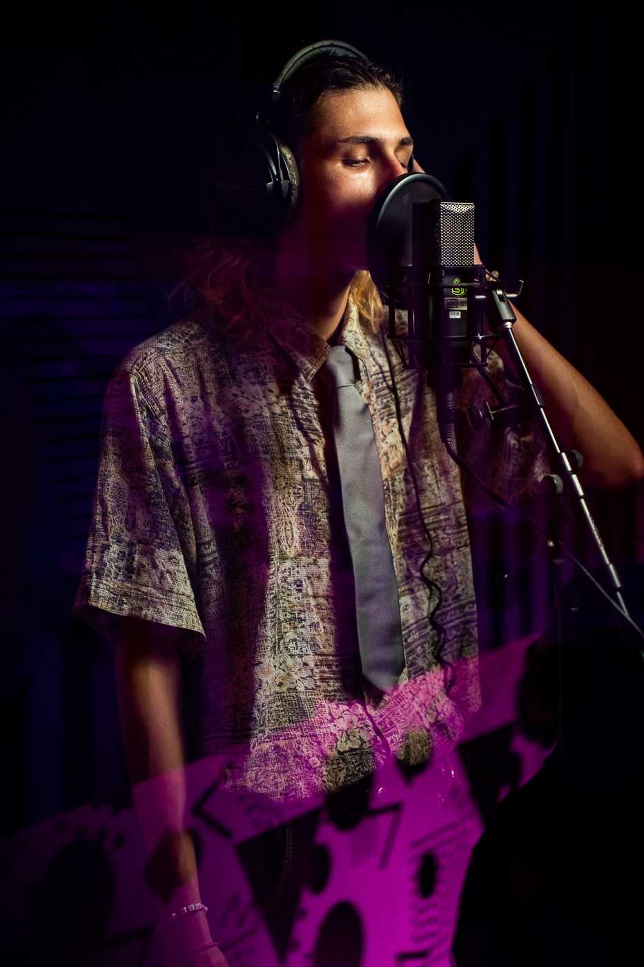 Man with microphone and headphones in studio