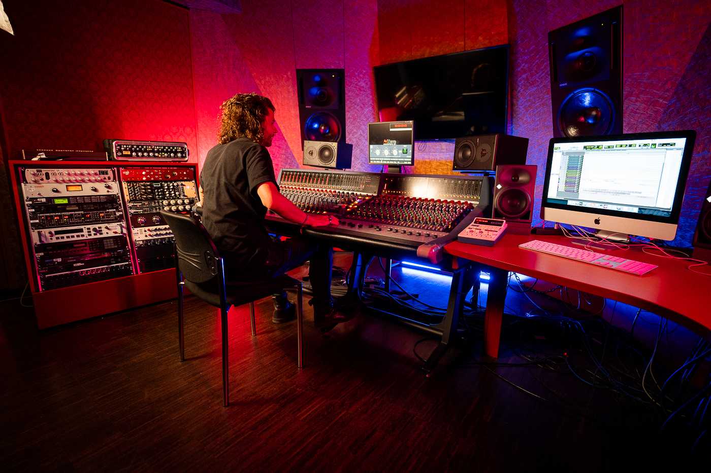 Man in Studio producing music on soundboard